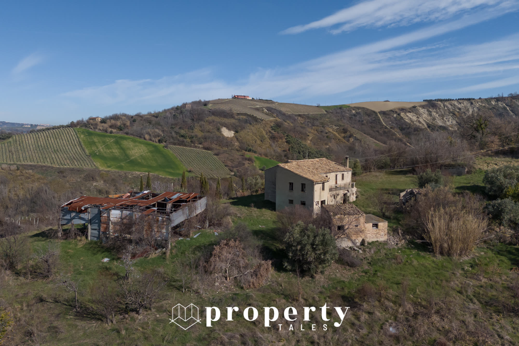 Aerial view of farmhouse and outbuildings